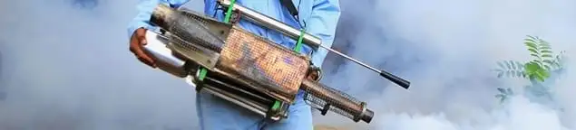 Fumigation technician using a fogger for deep pest treatment in Houston, TX